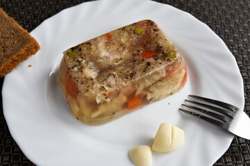 Pork aspic with vegetables on a plate