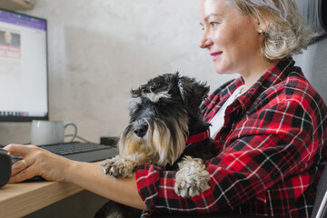 Senior Woman Working with Dog at Home Office