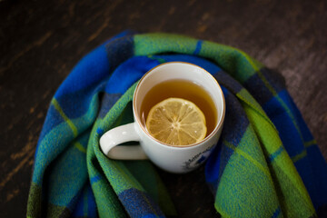Cup of hot tea with lemon and coffin scarf.