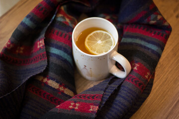 Cup of hot tea with lemon and coffin scarf.
