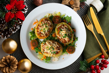 Baked potatoes stuffed with meat and baked in the oven. Top view table with Christmas decorations.
