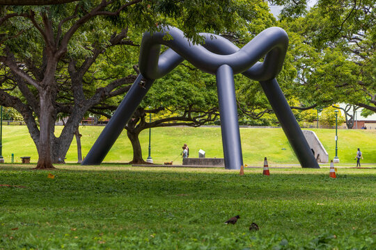 The Sky Gate sculpture at the Frank Fasi Civic Grounds with lush green trees, grass and plants in downtown Honolulu Hawaii USA.