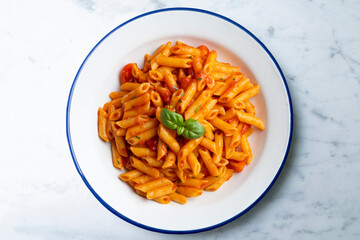 Macaroni with tomato and basil aroma. Top view table with  decorations.