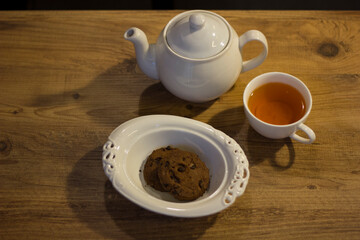 Autumn evening with tea, cookie and notebook.