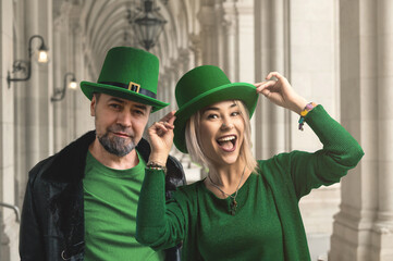 Happy couple wearing green hats is smiling and having fun celebrating saint patrick's day