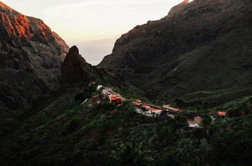 Beautiful small village La Masca in Tenerife (Canary Islands - Spain) on sunset. Horizontal photo of Masca and green hills and mountains during sunset.