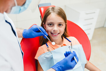 Close up photo of a little caucasian smiling preteen girl curing her teeth, dentist orthodontist...