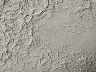 Surface of the wall where the paint partially wrinkled.