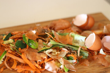 Chopping board with biowaste left from cooking. Selective focus.