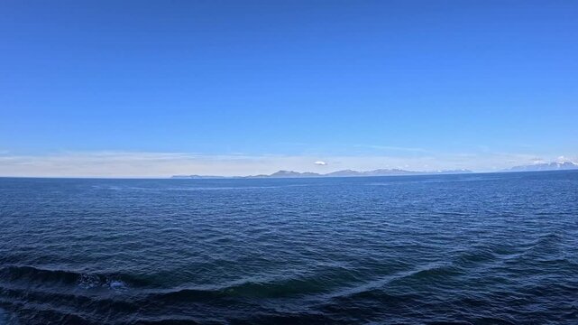 Nordfugl&oslash;ya, Nuorta-Vuovl&aacute;, Vannv&aring;g, Karls&oslash;y Municipality, Troms, Norway - timelapse slowly cruising on Norwegian Sea from Stjern&oslash;ya island enjoying the sunny ocean view