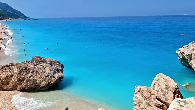 Kathisma Beach in Lefkada. Tropical Turquoise Sea with Huge Rocks and White Sand. 4k Cinematic Ionian Islands Landscape. Greece Summer.
