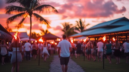 A vibrant sunset scene with people holding torches, creating a magical and festive atmosphere at a tropical resort.