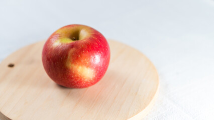 Fresh Red Apple on Wooden Cutting Board