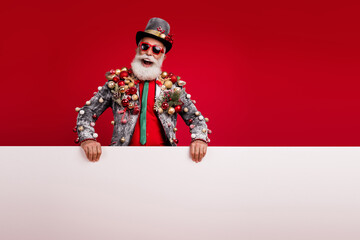 Photo of happy cheerful old man white banner sales wear christmas tree balls costume sunglasses isolated red color background