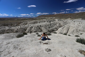 Altai Republic. Tourists pose against the background of Martian and Moon landscapes – deserted area with canyons.
