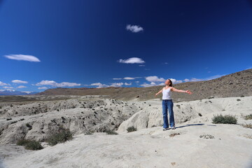 Altai Republic. Tourists pose against the background of Martian and Moon landscapes – deserted...