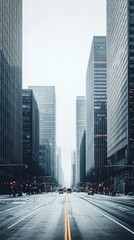 Obraz premium A tranquil street scene showcasing modern skyscrapers and an empty roadway, evoking a sense of urban calm amidst city hustle.