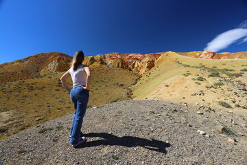 Fototapeta premium Altai Republic. Tourists pose against the background of Martian and Moon landscapes – deserted area with canyons.