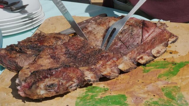 carne costillar de parrilla cooked on a table cut with a knife in latin america - meat concept