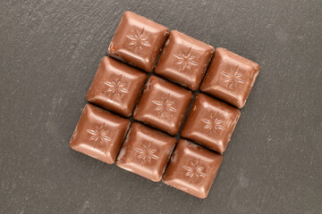Dark chocolate  on slate stone, macro, top view.