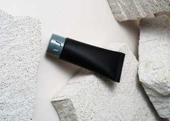 Black Bath Gel Tube on White Stone Background - Minimalist Product Mockup