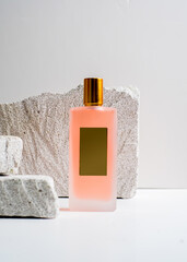 Elegant Peach Color Spray Perfume Bottle on White Stone Background - Minimalist Fragrance Mockup