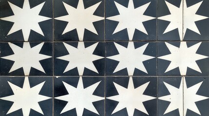 A repeating pattern of geometric stars in dark gray and white, arranged symmetrically across square tiles for a sharp, modern look.