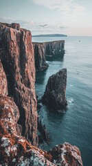 Stunning cliffside view overlooking tranquil ocean waters under a colorful sky, perfect for nature and travel enthusiasts.