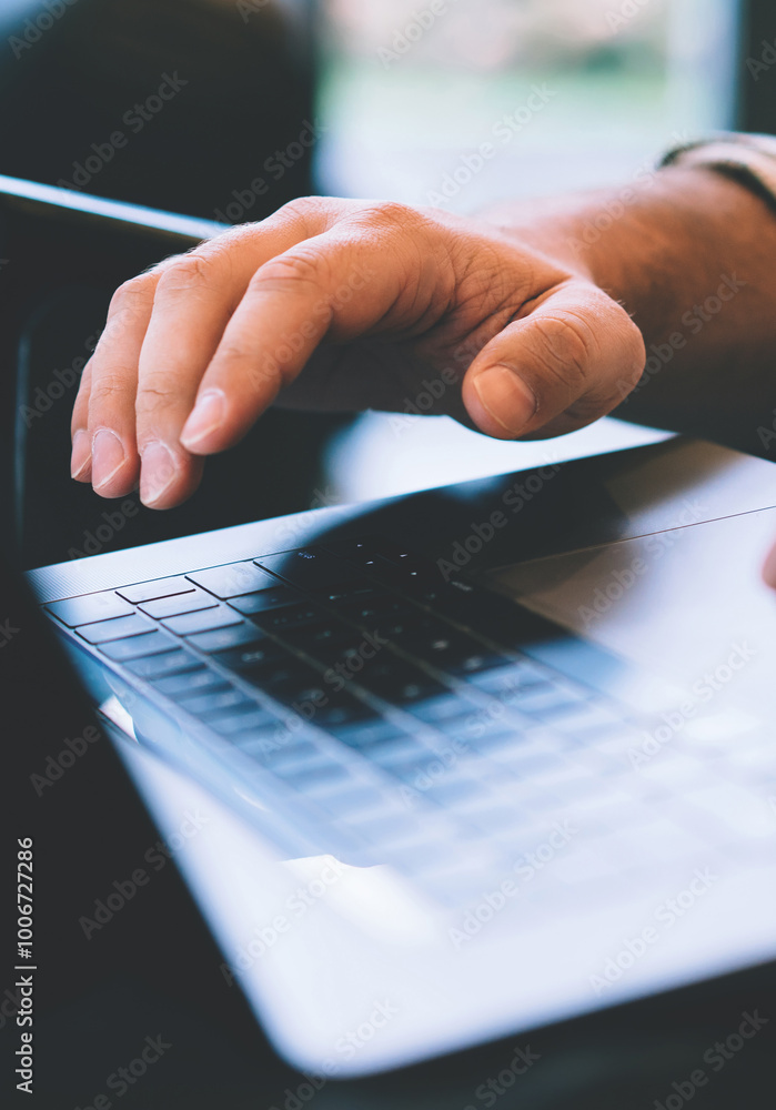 Poster close up view of male tattooed hands typing keyboarding email on laptop computer, cropped view with 