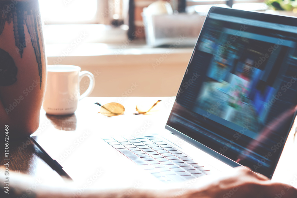 Poster cropped view of male using laptop computer with screen while sitting at wooden desktop table, male f