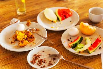 A dining table with plates of delicious food and steaming coffee