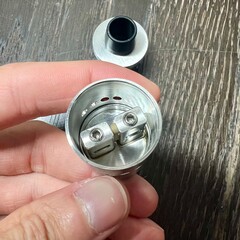 hand holding a metal can