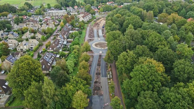 Beautiful aerial of road under construction with a newly built roundabout in a rural town in the Netherlands