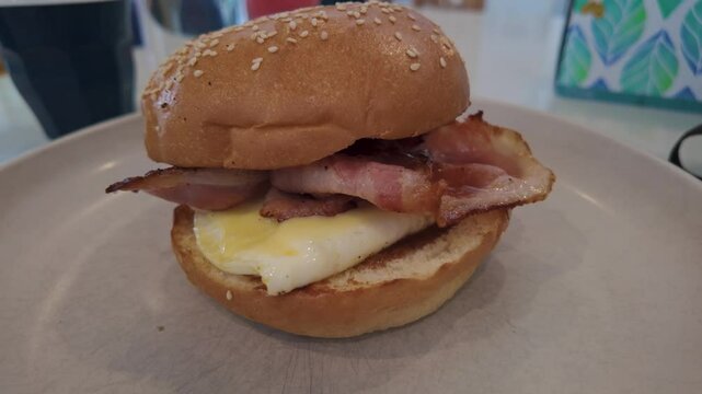 Bacon and egg roll for breakfast. zoom in.