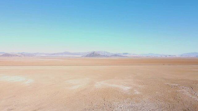 Drone push in on Nevada dry lake bed on a sunny summer day