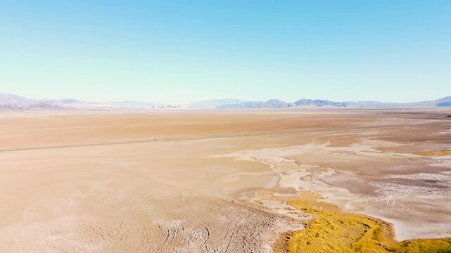 Sunny summer day drone across Nevada dry lake bed