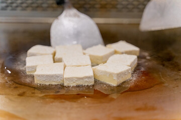 The fragrant Teppanyaki tofu is being prepared for each dish