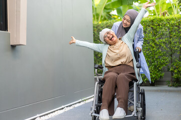 Female muslim doctor comforting elderly cancer patient in wheelchair, providing emotional support and medical care, outdoor healthcare, cancer patient care, illness support, compassionate treatment