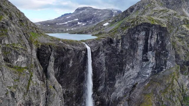 Epic waterfall in clouds zoom out drone shot, double waterfall of Mardalsfossen in Norway in 4K.