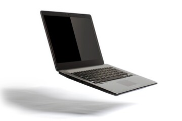 A laptop computer is open and sitting on a white surface, ready for use