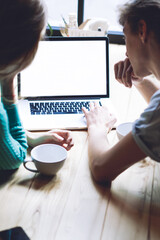Back view of romantic couple searching information about good hotels for making booking online on...