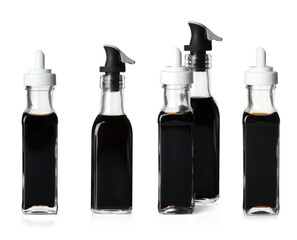 Tasty balsamic vinegar in bottles on white background, set