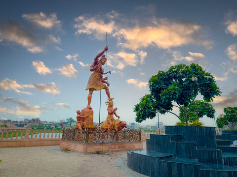 a divine statue of shiva the god between the lake - Powered by Adobe