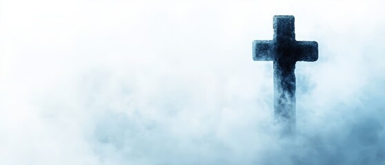  A cross located in the heart of a foggy expanse, its silhouette distinctly marked amidst the mist