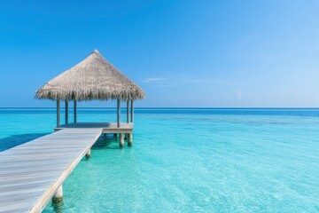 Beautiful blue sea and a wooden pier with a thatched roof on a tropical island.