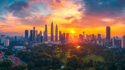 Selbstklebende Fototapeten Serene view of a Kuala Lumpur city skyline bathed in the warm glow of sunset, © Arifin Studio