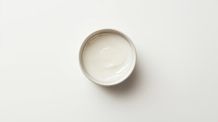 Close-up of the top view of a rich moisturizing cream in a circular container. Shiny, even texture with no logo. Clean white background for a minimal look.