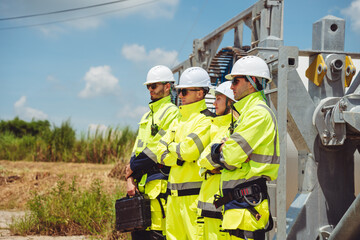 Team Engineers and Technicians Managing Wind Turbines Outdoors, Focused on Renewable Power Generation and Environmental Conservation. Sustainable Energy and Industrial Solutions for a Greener Future.