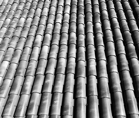 View of gray tiles on the roof of the house. Close-up.
