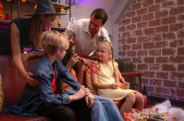 Parents and children are enjoying the halloween celebration party